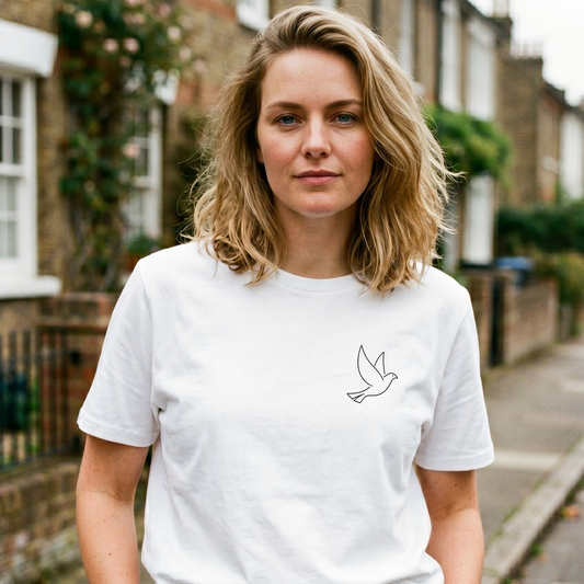 Woman wearing a white t-shirt with a bird design on a residential street.
