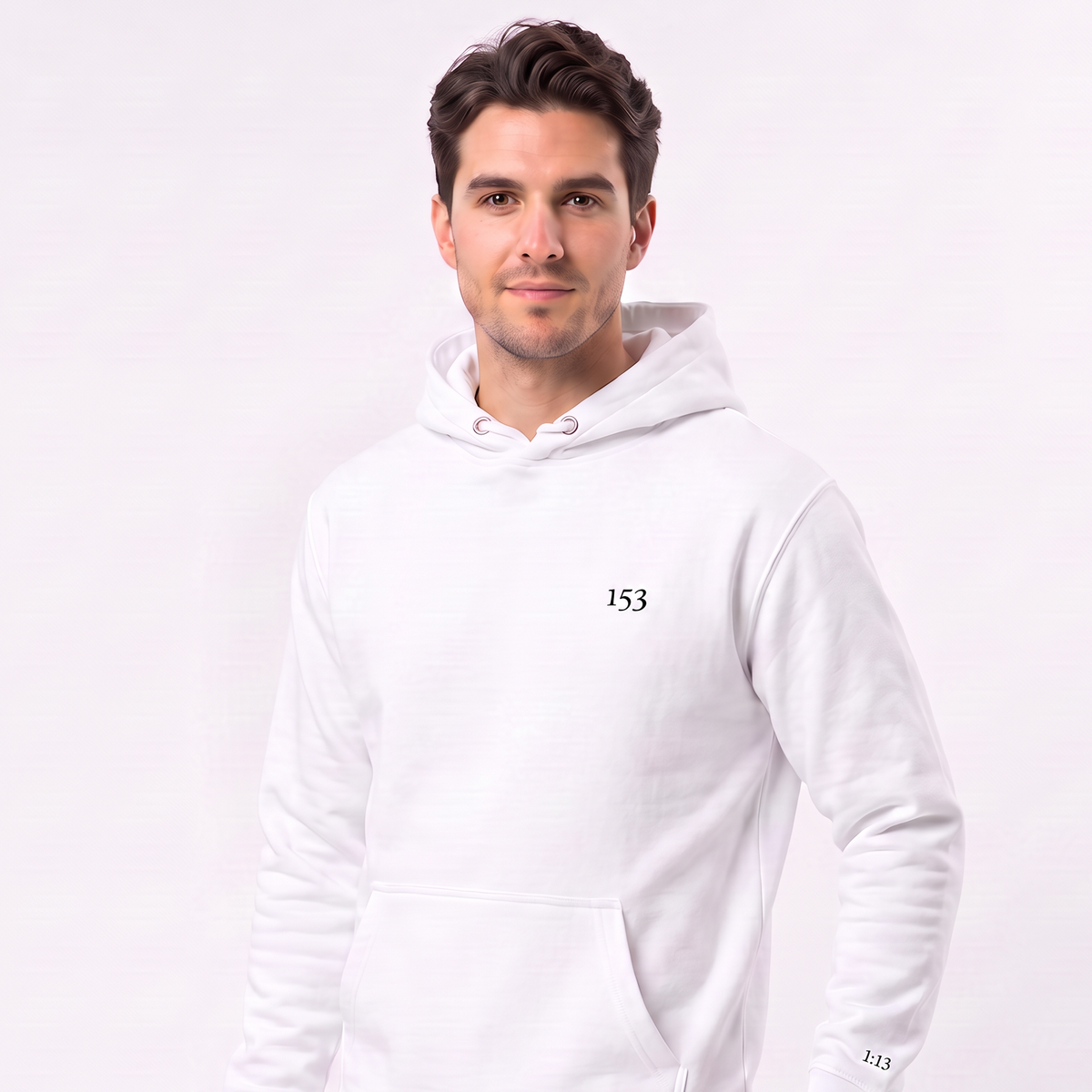 A man wearing a white pullover hoodie with a small black '153' logo on the left chest, paired with dark jeans, photographed against a clean white studio background.
