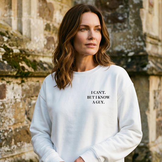 Woman wearing a white sweatshirt with text in front of a stone building
