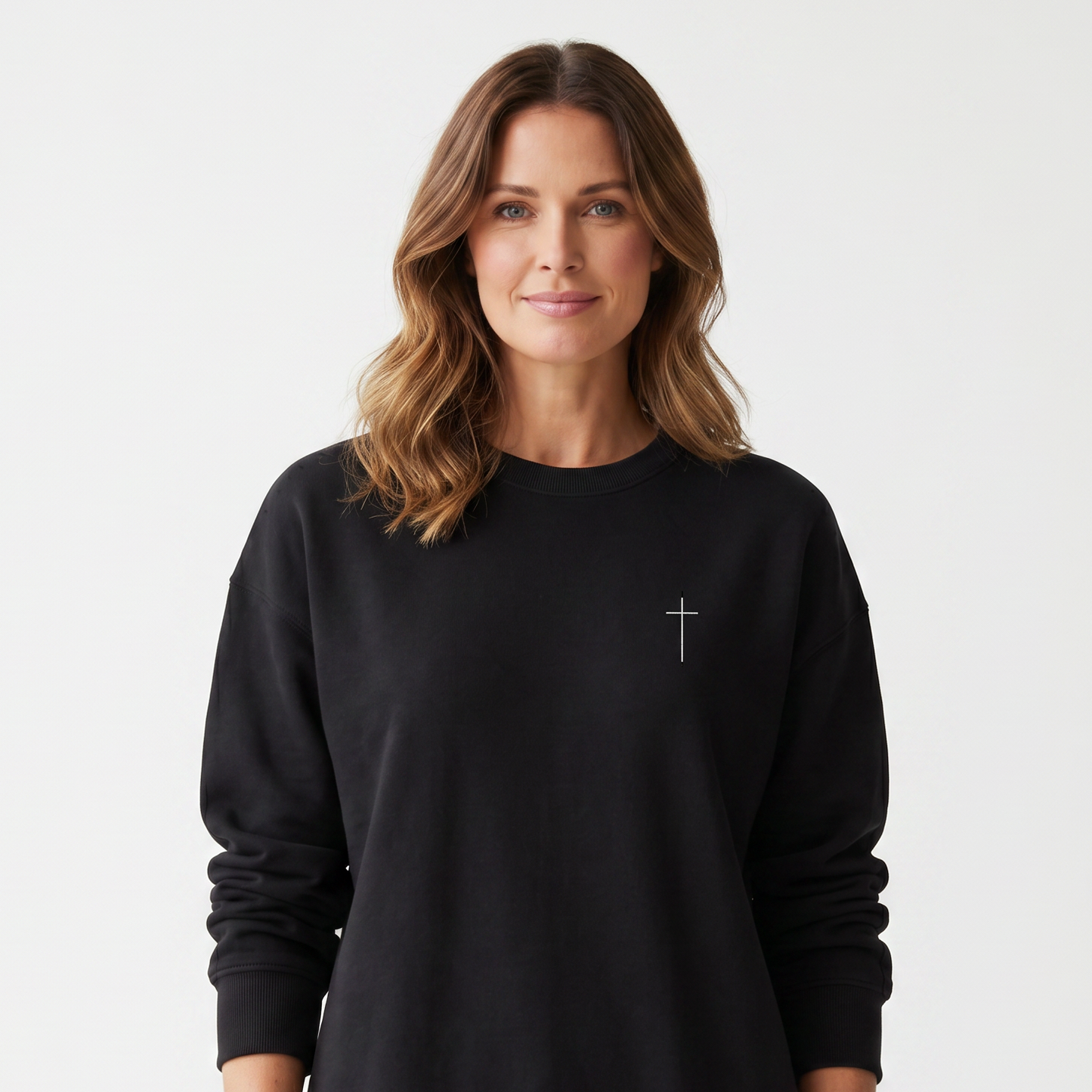 Woman wearing a black sweatshirt with a small logo on a white background