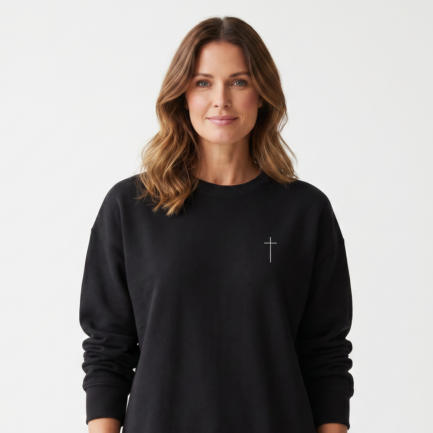 Woman wearing a black sweatshirt with a small logo on a white background
