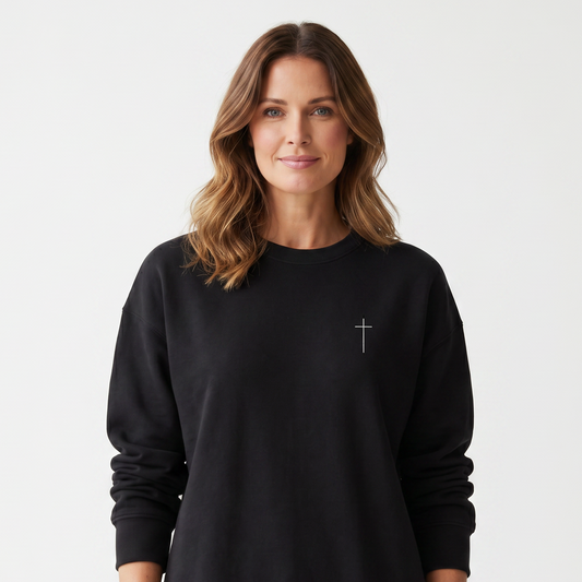 Woman wearing a black sweatshirt with a small logo on a white background